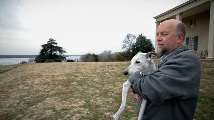 Mark Sutherland holds Abby the whippet outside Mount Vernon on their heartfelt journey