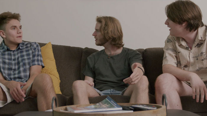 Brian, Sean, and Owen talking on the couch in Hometown Summer
