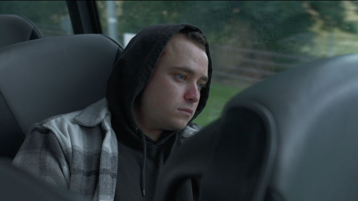 Joey sits alone on a bus, looking out the window in Joey Had Never Been Out of the City