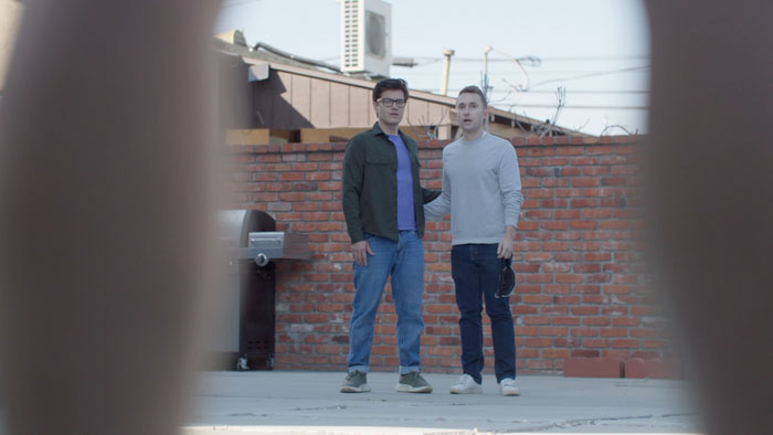 Ben Baur and Matthew Bridges seen through Eddie Liu's legs in Just Between Us
