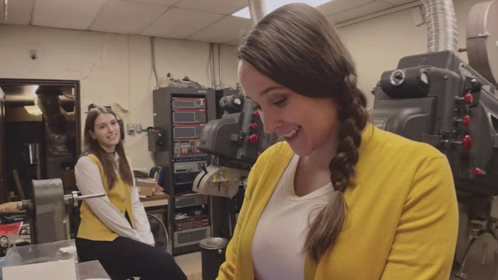 Movie theater staff working in projection room in Movie Theater Massacre