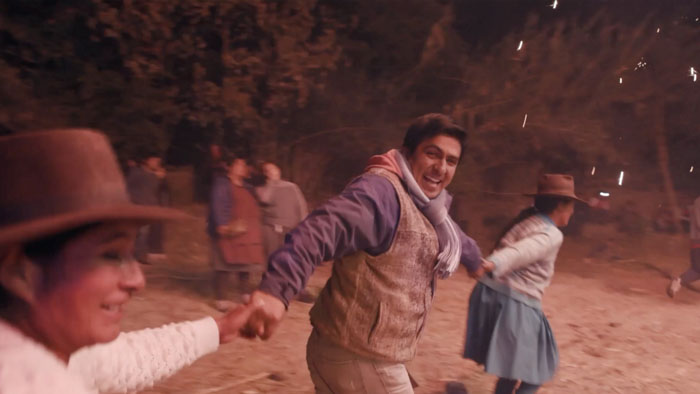 Fernando Valencia dances joyfully during a nighttime Quechua celebration