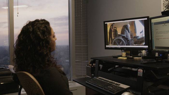 Melissa Miller watches surveillance footage from a long-term care facility in Stolen Time.