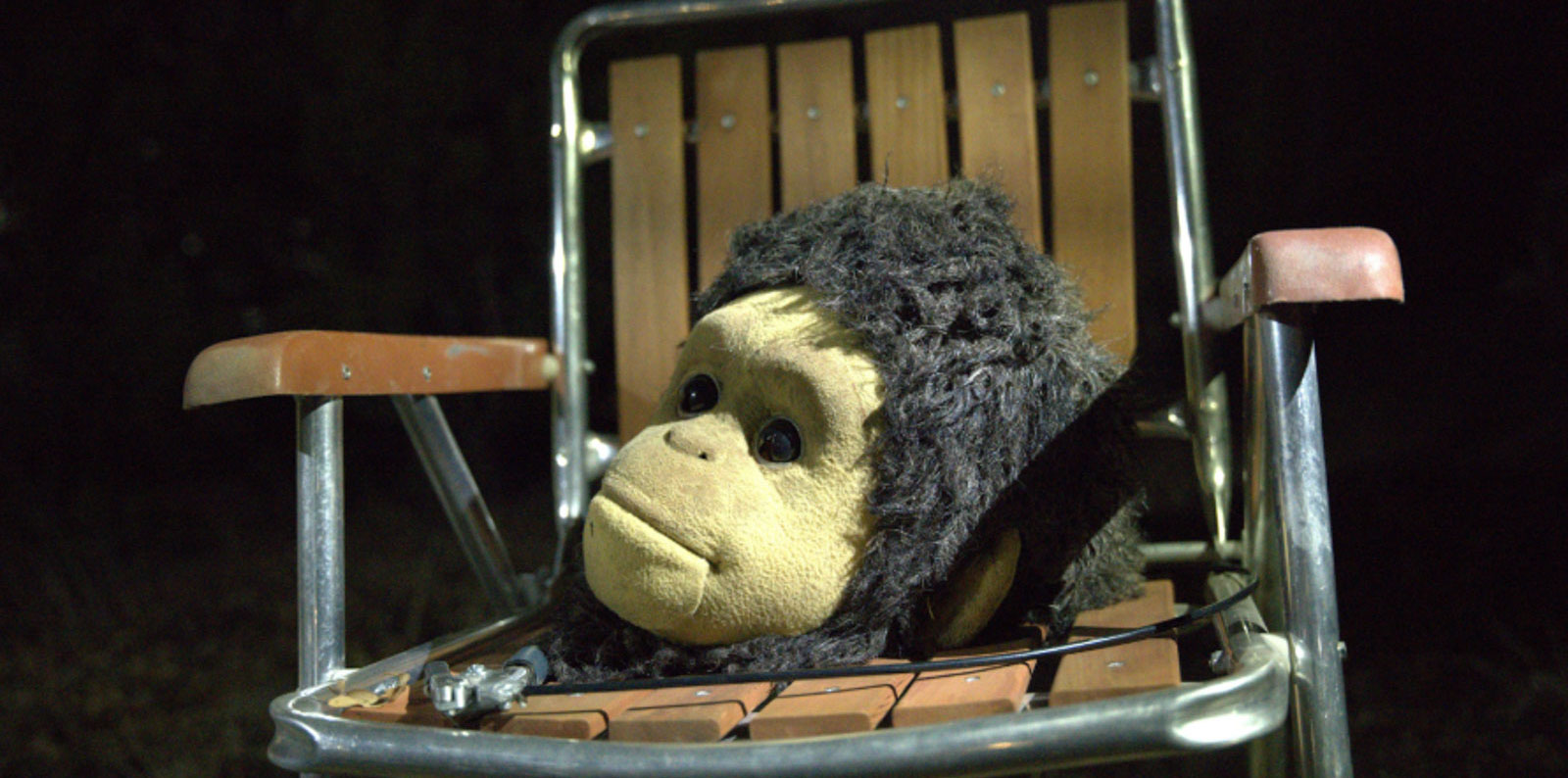 Monkey costume head resting on a lawn chair in Sunlight movie scene.