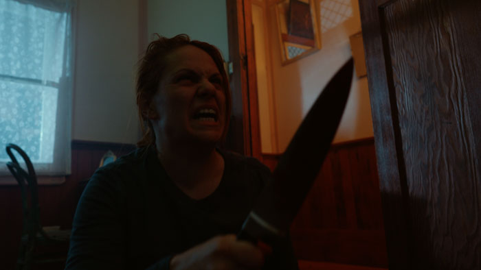 Kate Logan as Annette, wielding a knife in a terrifying rage in The Matriarch