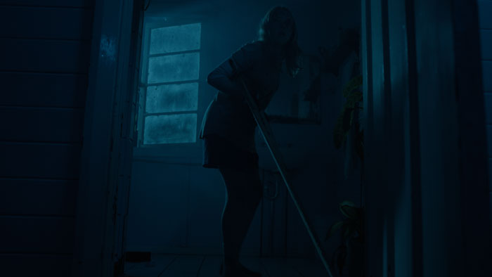 Missy hides in the shadows with a weapon in The Matriarch (2025)