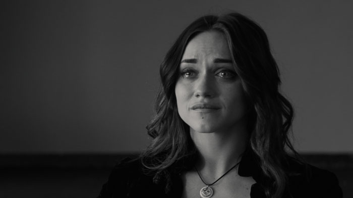 Morana gazes ahead with tears in her eyes in a black-and-white still from The Wanderer