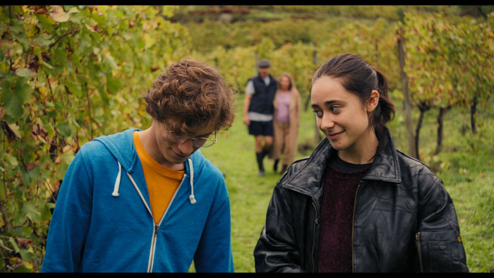 Tomás and Belinha walk through the vineyards in Autumn