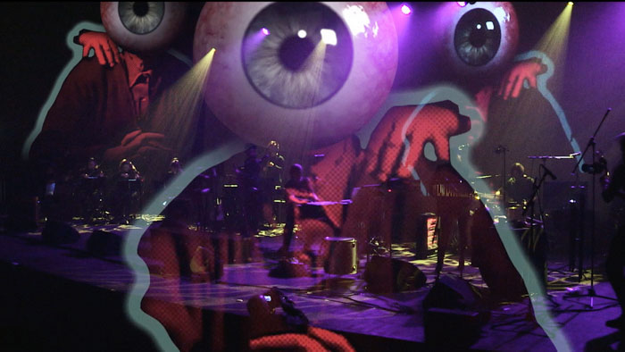 Concert stage with eerie eyeball animation overlay from The Dark Fantastic