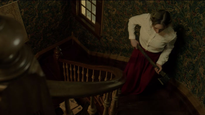 Woman holding axe on a staircase in The Lizzie Borden Game