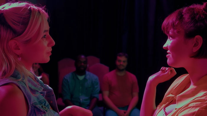 Charlotte and Aubrey connect during an improv performance