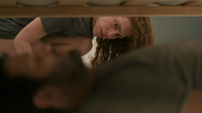 Rotem discovers Nadav hiding under the bed in a tense moment from Elephant in the Desert.