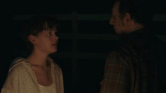 Emma and Aaron face off in a tense nighttime scene from Mia (2025).