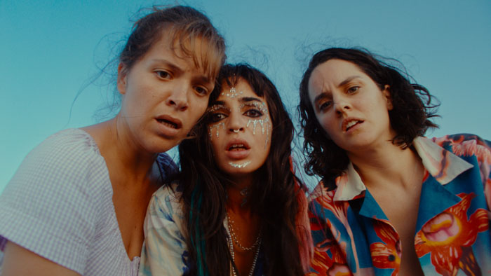 Scene from The Balconettes with Sanda Codreanu, Souheila Yacoub, and Noémie Merlant under a clear sky