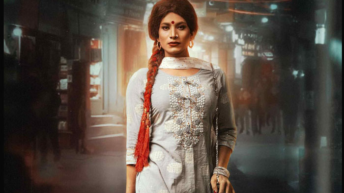 Gulabi standing in a Kathmandu street wearing a traditional dress in Gunyo Cholo: The Dress