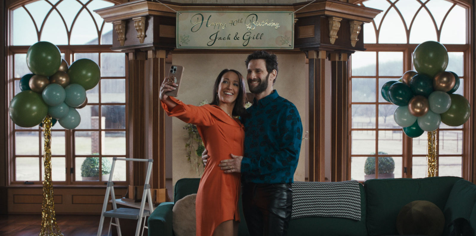 Couple takes a selfie under a "Happy 40th Birthday Jack & Gill" banner in Nuked