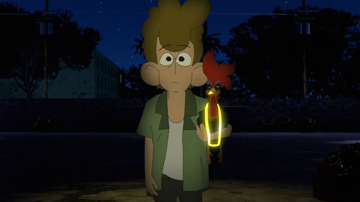 The owner of Yunian the rooster stands in a dimly lit street at night, holding the rooster in his hands.