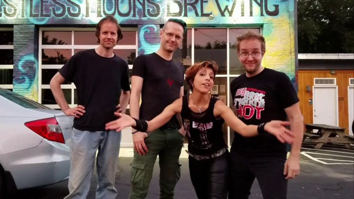 Butterfly Vendetta band posing outside Restless Moons Brewing