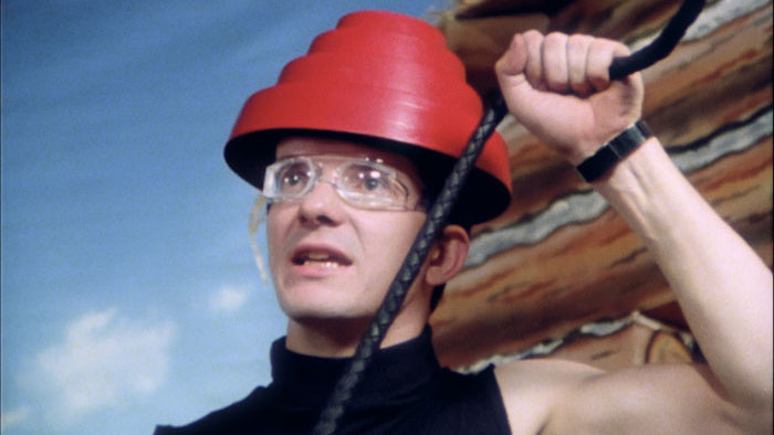 Devo band members performing in their red energy dome hats.