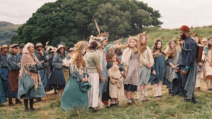 Villagers gather in the fields during a harvest ritual in Harvest (2024).