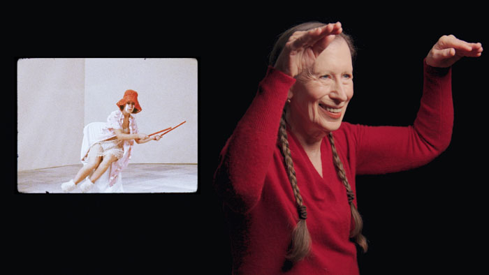 Meredith Monk raising her arms during a performance alongside archival footage in Monk In Pieces.