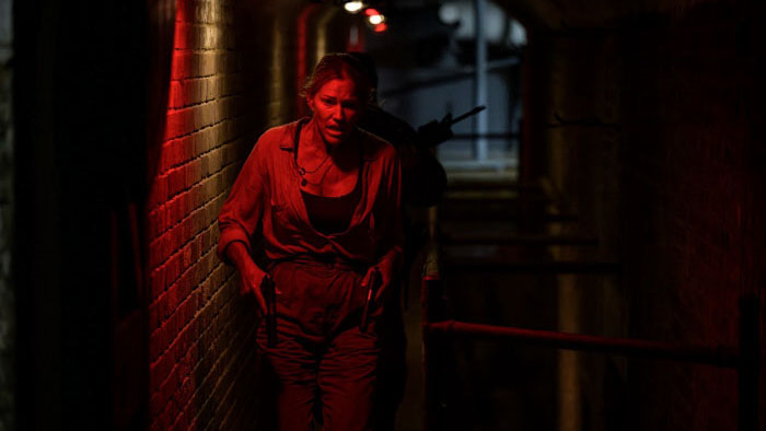 A woman in a red-lit corridor in Primitive War