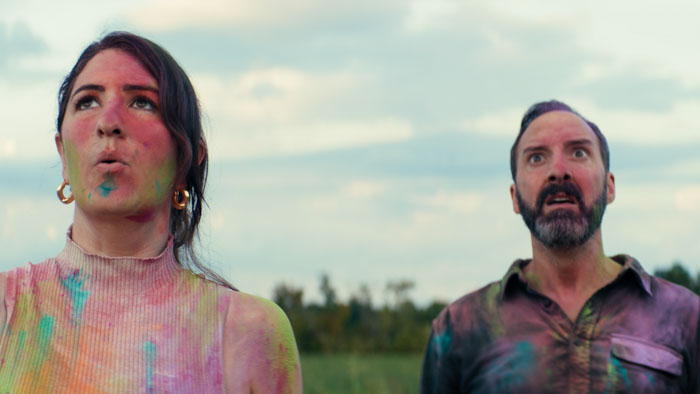 D’Arcy Carden and Tony Hale covered in paint staring in shock in a scene from SketchTitle: D’Arcy Carden and Tony Hale in Sketch
