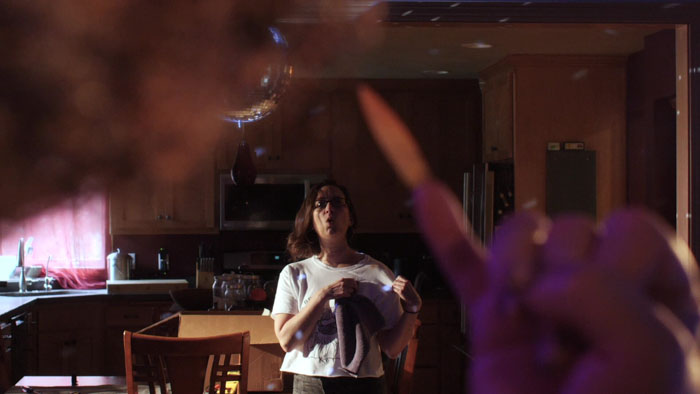 Kate Houle in a tense kitchen scene from the horror-comedy The Xxtra Deadd