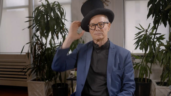 Bill Irwin adjusting his top hat during an interview in American Clown (2025).