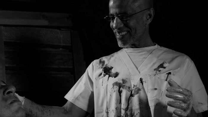 A sadistic doctor smiles during an interrogation in Jordan Rockwell’s short film Traitor.