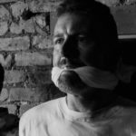 A captive soldier gagged and facing interrogation in Traitor.