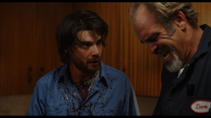 Daniel Doheny covered in blood during a tense scene from Scared Shitless.