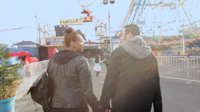 Jocelynn Catasús and Jon Navarro walk hand in hand along the Coney Island boardwalk in Soledad.