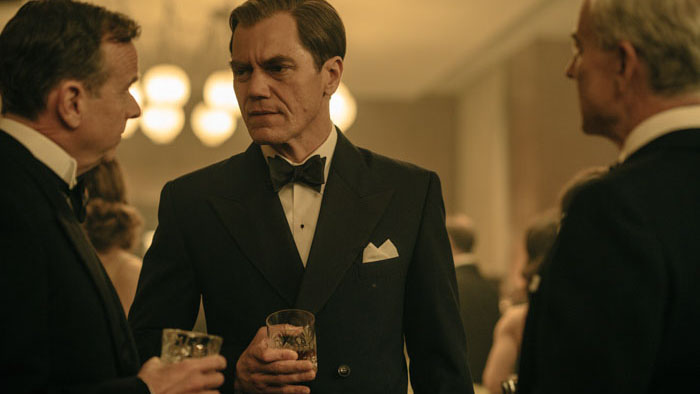 Michael Shannon as Robert H. Jackson converses during a formal reception in Nuremberg.