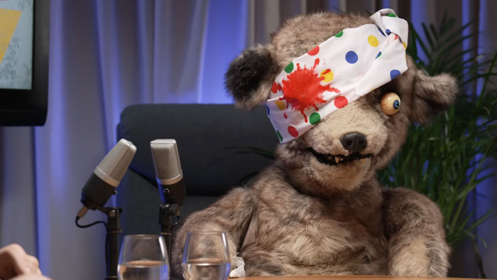 Pads, the Spitting Image bear, dressed in a parody of Pudsey Bear with a spotted eye bandage.