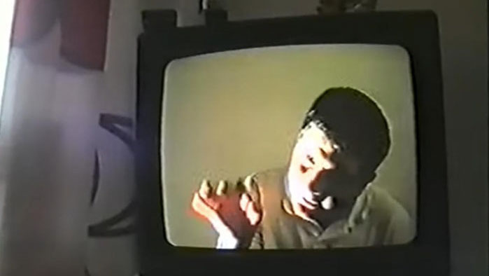 A scene from TV Man showing a man appearing inside an old CRT television screen.