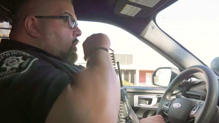 Vinnie Montez performs an animated stand-up routine onstage in Vinnie-isms: The Story of the Cop Comedian.