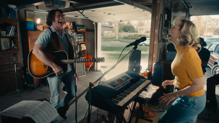 Hugh Jackman and Kate Hudson rehearse music in a garage in Song Sung Blue (2025).