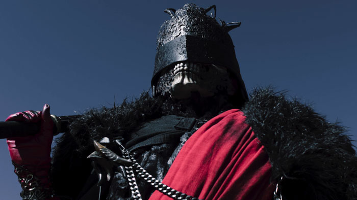 The Fester Knight, a masked enforcer of the Scarlet Prince in Suffer (2025)