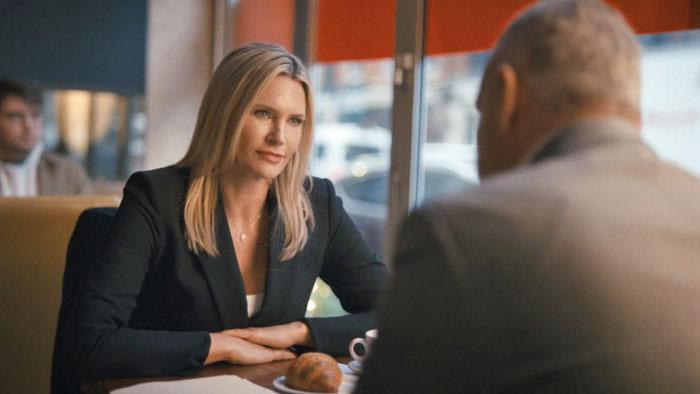 Natasha Henstridge sits across from a man at a coffee shop in Another Day in America.