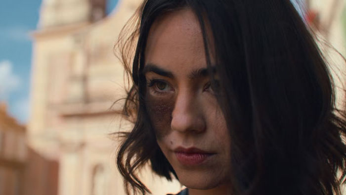 Cassandra Naud as CW in Influencers (2025) with distinctive facial birthmark in dramatic close-up