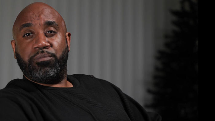 Clive Christopher sits for an interview in Skywatch (2026).
