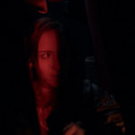 Crystal Loverro as Maria hiding in a dark closet from an alien predator in Blindsided (2025)