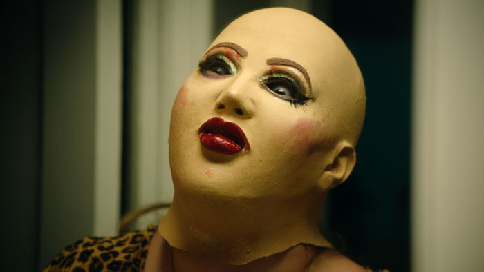 Francis (Dina Silva) wears a heavy makeup mask in Frankie, Maniac Woman.