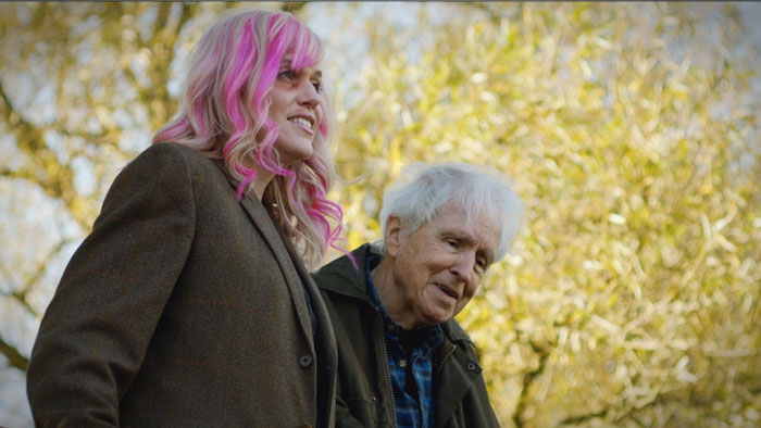 Magda (Melissa De Mol) and Guy (Alan Breck) walking together outdoors in Gone to Ground (2026) 