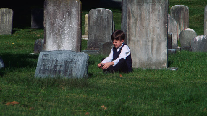 Brian Gajewski (Stanley Trub) sits in a cemetery in Mamochka.
