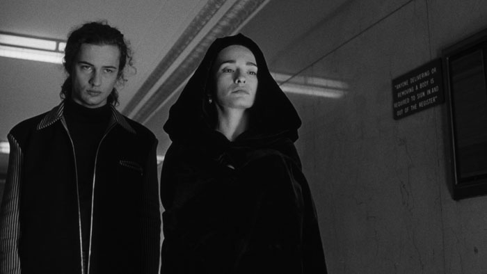 Nadja (Elina Löwensohn) and Edgar (Jared Harris) walking through a corridor in Nadja.