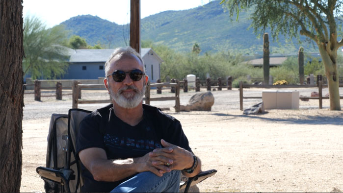 Dan Starkey seated outdoors in Arizona desert during Skywatcher documentary