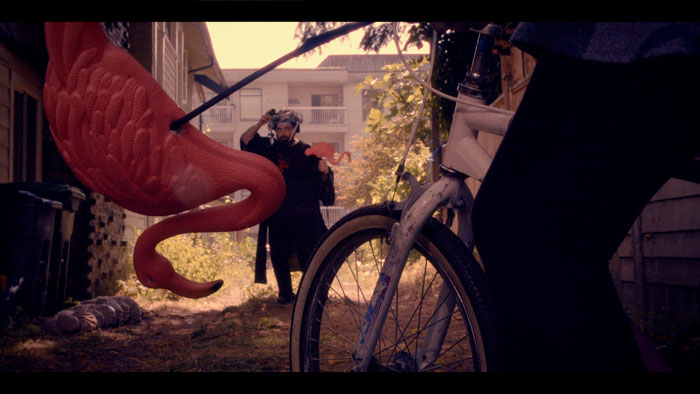 Donald Voltman (Peter New) wears the time helmet in a neon-lit bar while his neighbor Ferris (Lou Ticzon) looks on in Time Helmet (2026).