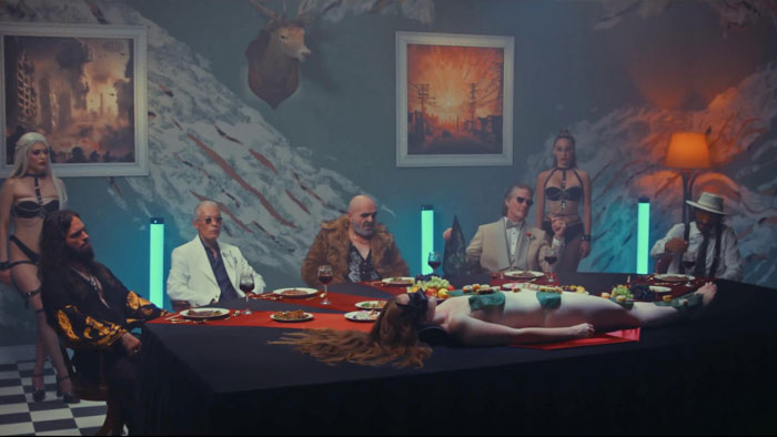 Crime lords gather around a lavish dinner table in 12 Warriors, with Abel (Costas Mandylor) presiding.